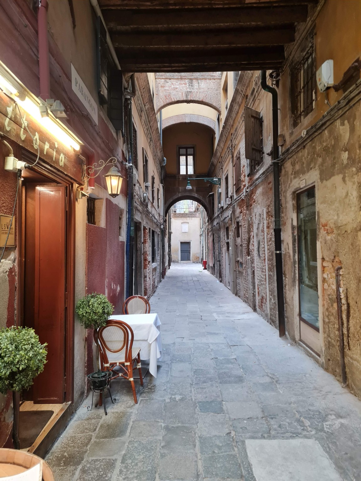 Quiet alley with a restaurant table