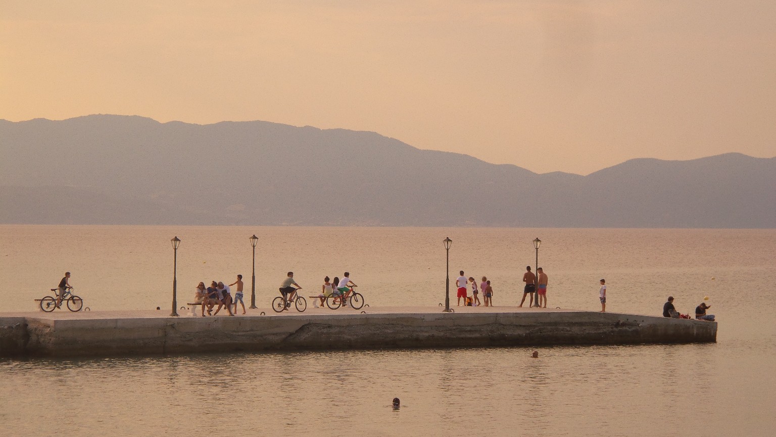 People gathered on a pier by the sea